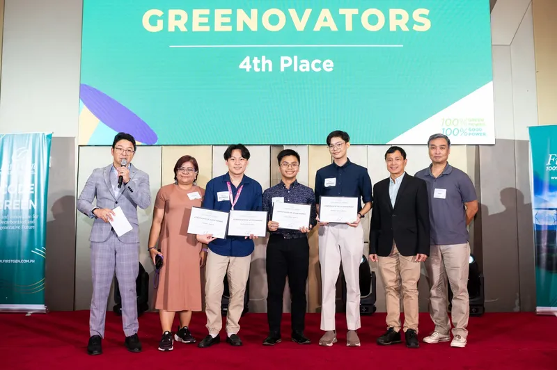 Team Greenovators on stage at Code Green, holding certificates under a 4th Place screen
